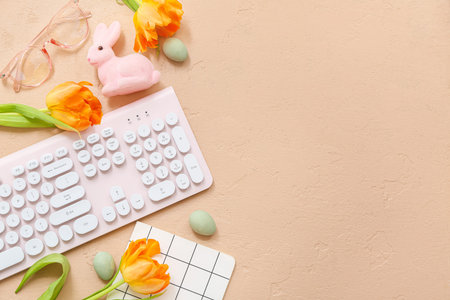Composition with modern keyboard, tulip flowers and Easter decor on color background