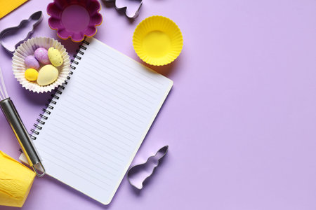 Blank notepad for recipes with Easter eggs and baking tools on lilac background