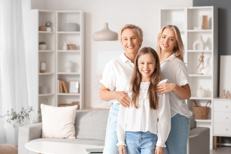 Little girl with her mom and grandmother smiling at home