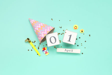 Calendar with party decor on turquoise background. April Fools Day celebrationの写真素材
