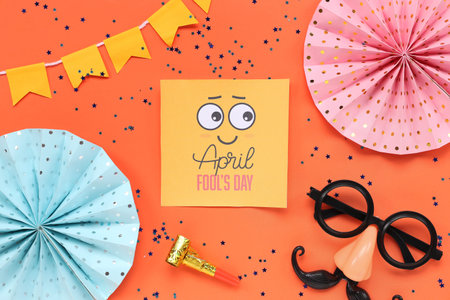 Festive postcard for April Fools Day with funny glasses and party decor on orange background