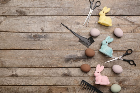 Hairdressing accessories with Easter eggs and bunnies on wooden backgroundの写真素材