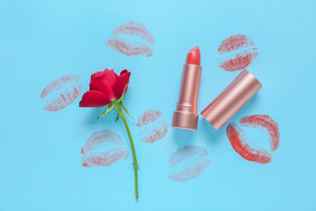 Lipstick with kisses and red rose on blue backgroundの写真素材
