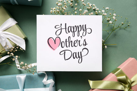 Card with text HAPPY MOTHER'S DAY, gift boxes and gypsophila flowers on gray background, closeup