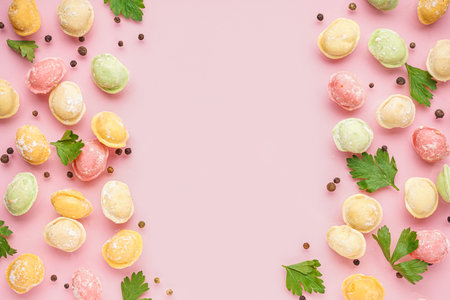 Colorful raw dumplings with peppercorn and parsley on pink backgroundの写真素材