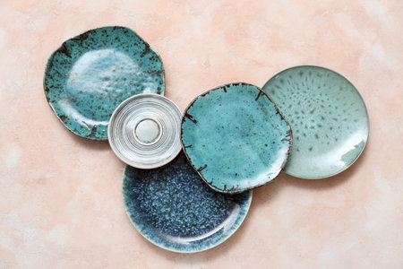 Set of stylish clean blue plates on beige backgroundの写真素材