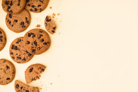 Tasty cookies with chocolate chips on yellow background