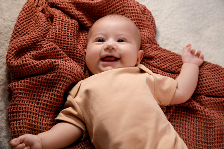 Cute little baby lying on bed at night, closeup