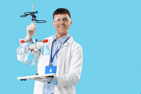 Male chemist with flasks on blue background