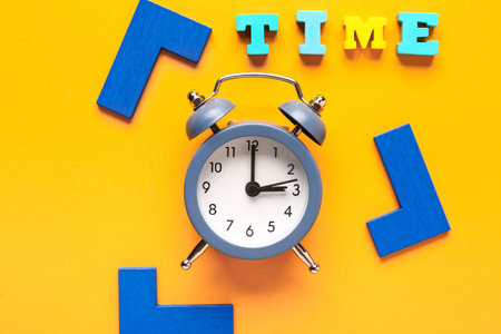 Word TIME and alarm clock on orange background. Time management. Top viewの写真素材