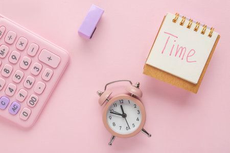 Notebook with word TIME, alarm clock and calculator on pink background. Top view