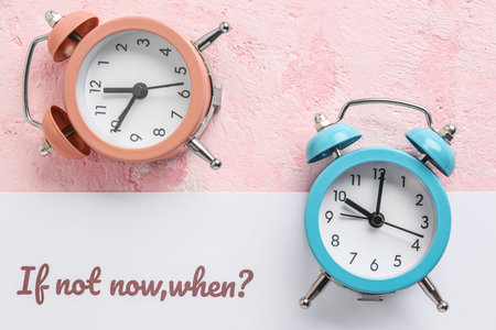 Paper with text IF NOT NOW, WHEN? and alarm clocks on pink background. Top view