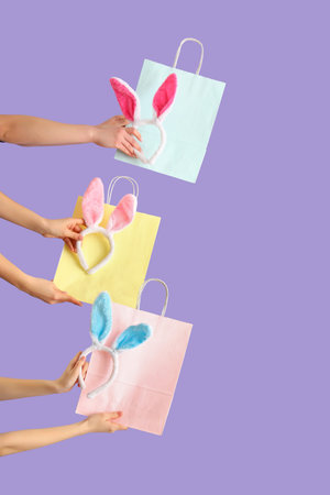 Women with shopping bags and bunny ears on lilac background. Easter Sale