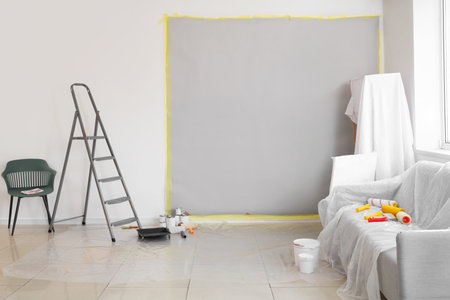 Covered furniture with repair tools in room