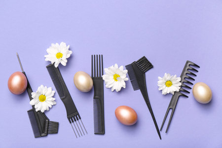 Hairdressing accessories with daisies and Easter eggs on lilac backgroundの写真素材