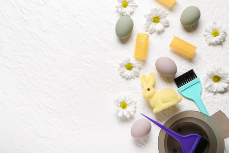 Hairdressing accessories with daisies, Easter eggs and bunny on white grunge backgroundの写真素材