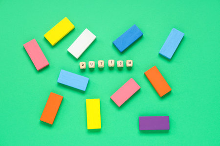 Word AUTISM and colorful blocks on green backgroundの写真素材