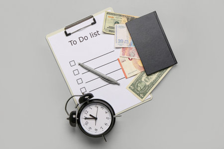 Composition with to do list, alarm clock and money on gray background. Time management concept. Top...