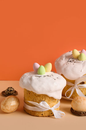 Composition with delicious Easter cakes and painted eggs on color background. Top view