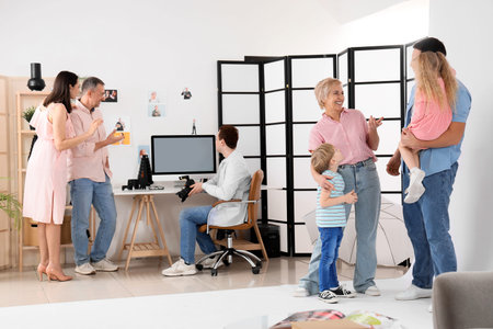 Male photographer with big family after photo shoot in studio