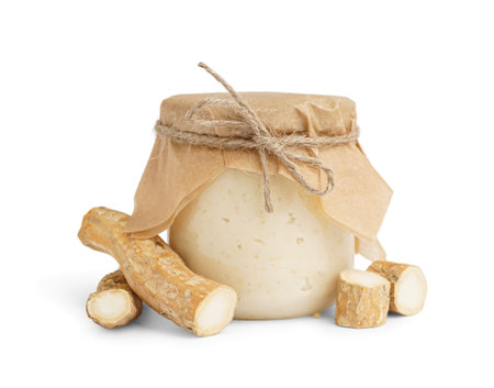 Horseradish sauce in jar on white background