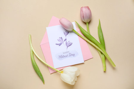 Envelope with festive postcard and tulips on beige background. Mother's Day celebration