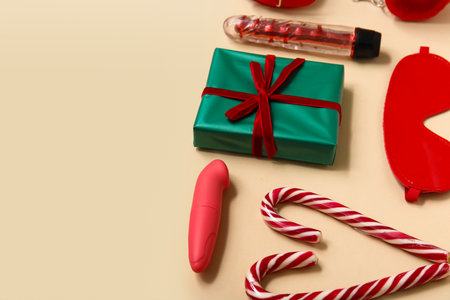 Different sex toys with gift box and candy canes on yellow backgroundの写真素材