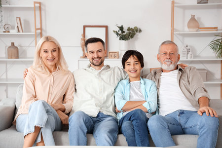 Little boy with his family sitting on sofa at home