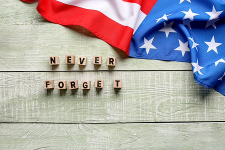 Blocks with inscription in memory of National Day of Prayer and Remembrance for the Victims of the Terrorist Attacks on light wooden backgroundの写真素材