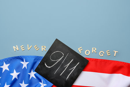 USA flag and card with date of National Day of Prayer and Remembrance for the Victims of the Terrorist Attacks on gray backgroundの写真素材