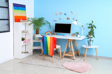 Interior of office with workplace, LGBT flag and paintingの写真素材