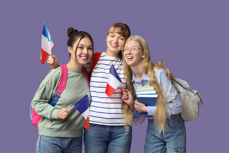 Female students with French flags on lilac backgroundの写真素材