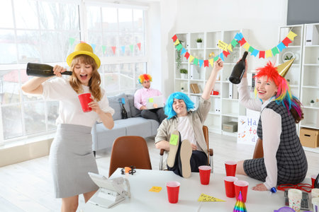 Business people with drink celebrating April Fools' Day at office party