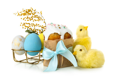 Tasty Easter cake, chicks and holder with eggs on white background