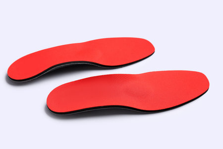 Red comfortable orthopedic insoles isolated on white backgroundの写真素材