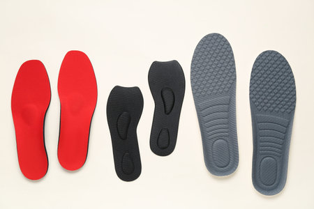 Many orthopedic insoles on white background
