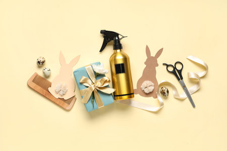 Composition with hairdresser's supplies, gift box and Easter decor on color backgroundの写真素材