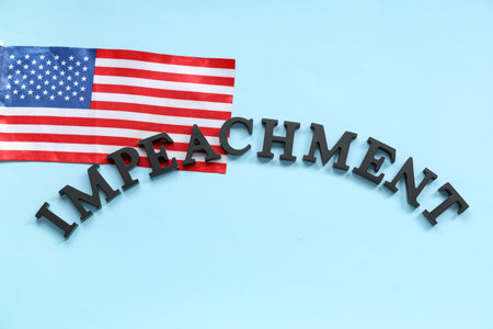 Black letters spelling word IMPEACHMENT and USA flag on blue backgroundの写真素材