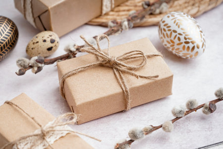 Painted Easter eggs with gift boxes and branches of pussy willow on white grunge backgroundの写真素材