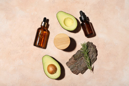 Composition with cosmetic products, avocado and tree bark on color backgroundの写真素材