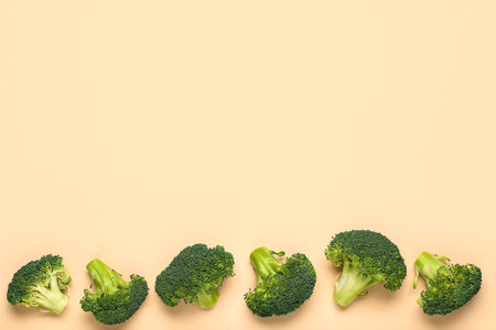 Fresh broccoli cabbages on beige backgroundの写真素材