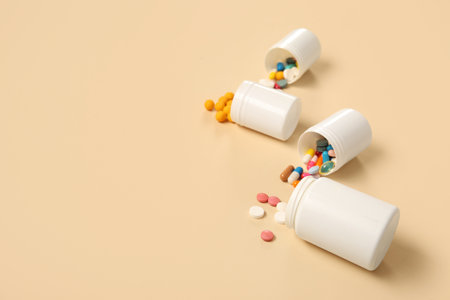 Jars with different pills on yellow backgroundの写真素材