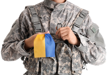 Male soldier with flag of Ukraine on white backgroundの写真素材