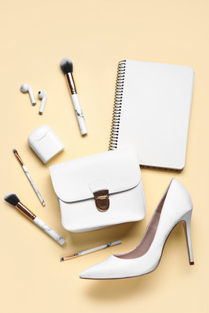 Composition with stylish high heeled shoe, accessories and earphones on color backgroundの写真素材