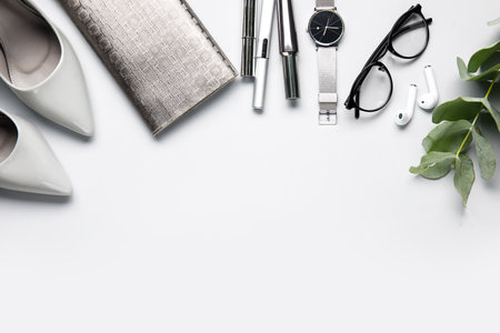 Composition with stylish female accessories, cosmetics and earphones on light backgroundの写真素材