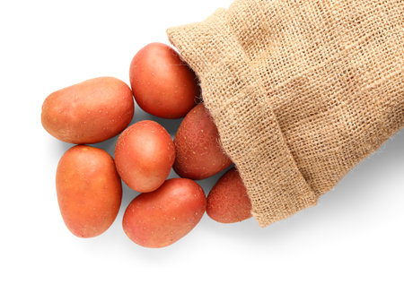 Sack bag with fresh raw potatoes on white backgroundの写真素材