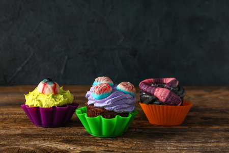Delicious Halloween cupcakes on wooden backgroundの写真素材