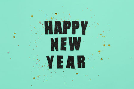 Text HAPPY NEW YEAR and confetti on turquoise background
