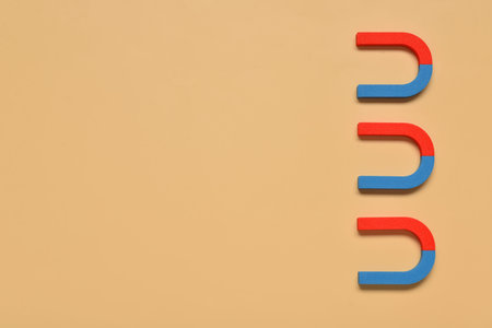 Horseshoe shaped magnets on orange background