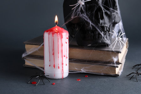 Wax candle and decor for Halloween on black backgroundの写真素材